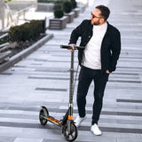 Trotineta pentru Copii si Adulti Elindor® cu Amortizor, Pliabila, pentru Freestyle, Fete si Baieti, Ghidon Ajustabil 78 - 105 cm, Frana din Miscare, Greutate Maxima Suportata 200 kg, Suprafata Antiderapanta, Negru